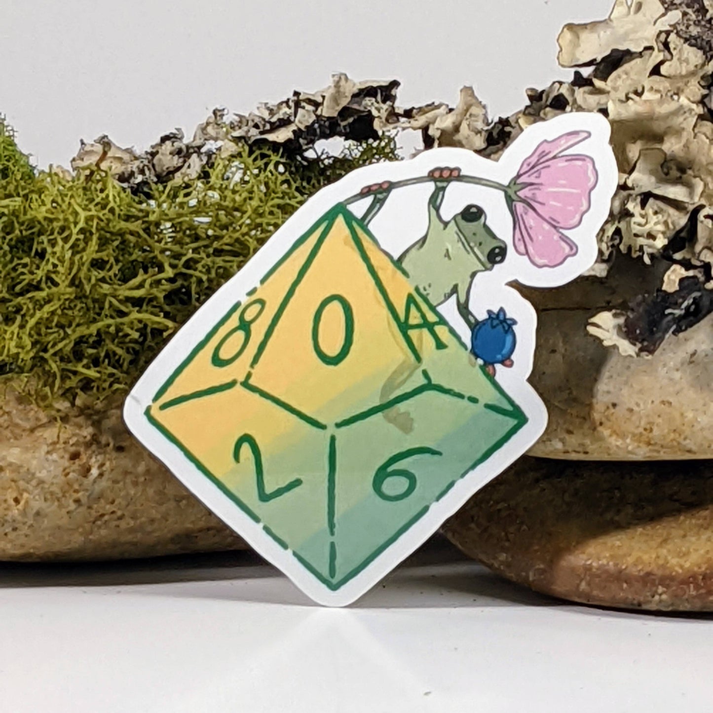 Flower Frog Hanging From Polyhedral Dice Sticker - 2.5"